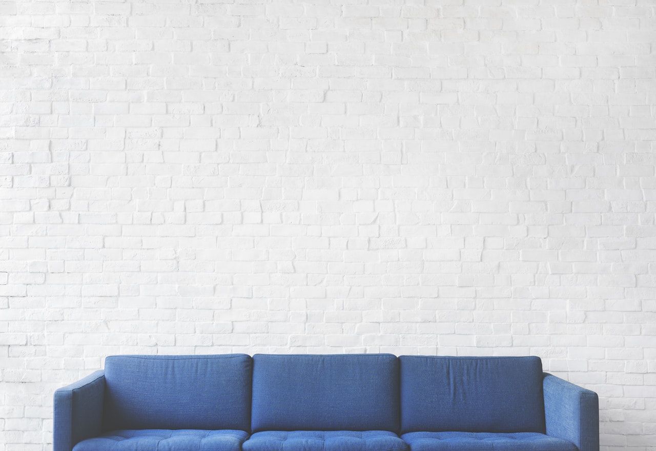 a blue couch and white wall